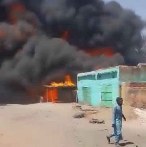 A large plume of smoke rises over the city of Ed Daein in Darfur on March 8, 2026, after an army drone strike targeted a fuel market.