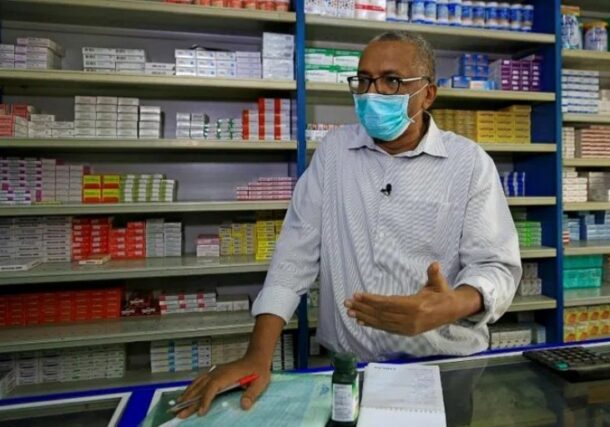 A pharmacist discusses the acute shortage of medicines at a drugstore in Khartoum, Sudan, March 20, 2026.