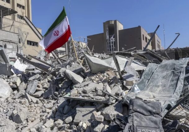 An Iranian flag is planted in the rubble of a police station, damaged in airstrikes yesterday, on March 3, 2026 in Tehran, Iran.Getty Images