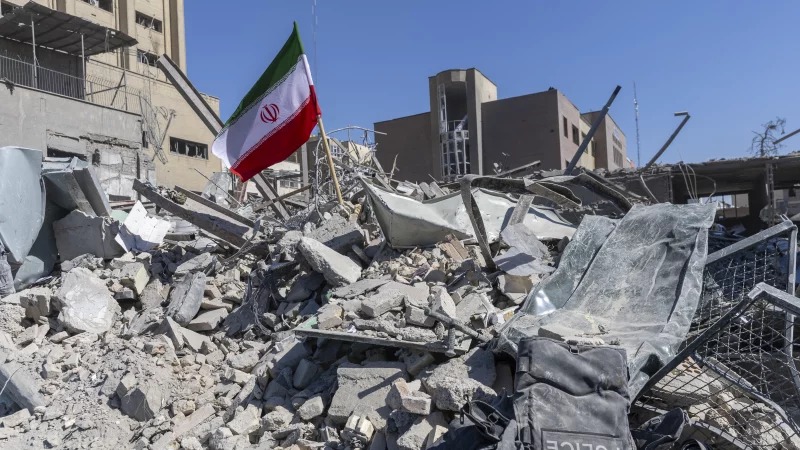 An Iranian flag is planted in the rubble of a police station, damaged in airstrikes yesterday, on March 3, 2026 in Tehran, Iran.Getty Images