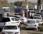 People wait to get fuel for their vehicles at a petrol station in Khartoum, Reuters file photo.