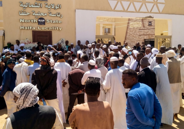 Residents gather in protest outside the North State Halfa Locality headquarters on March 8, 2026, to reject a proposed housing plan