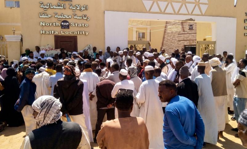 Residents gather in protest outside the North State Halfa Locality headquarters on March 8, 2026, to reject a proposed housing plan