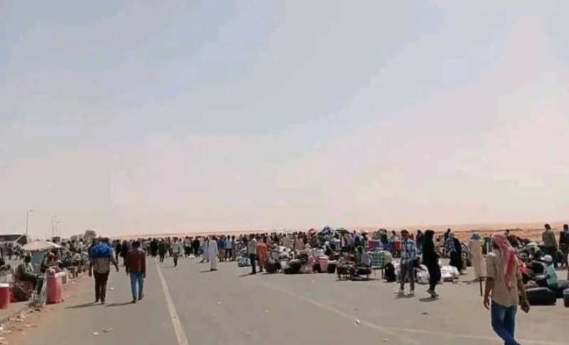 Sudanese returnees wait for transportation at the Arqin crossing on the border with Egypt after bus operators suspended a strike over tax hikes, March 27, 2026.