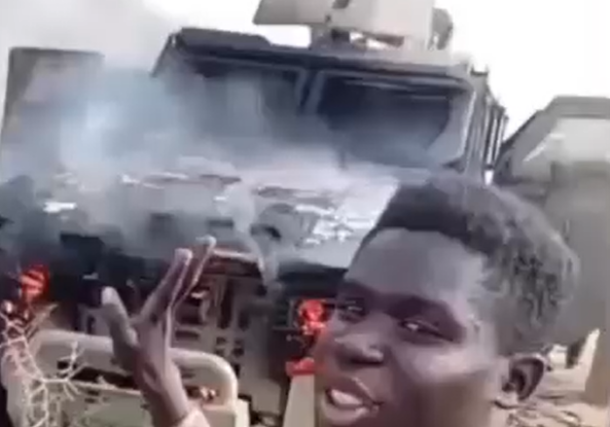 Sudanese soldiers stand besides an RSF destroyed vehicle in Dilling on March 28, 2026