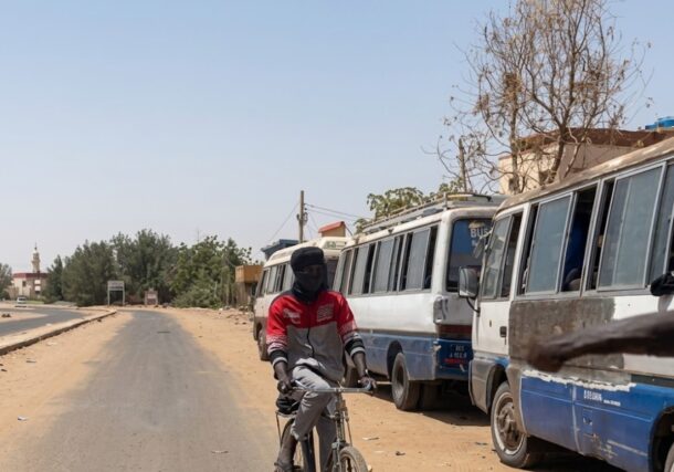 Buses wait for passengers on a street in Khartoum, Sudan, March 13, 2026.