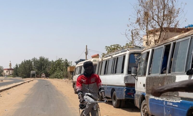 Buses wait for passengers on a street in Khartoum, Sudan, March 13, 2026.