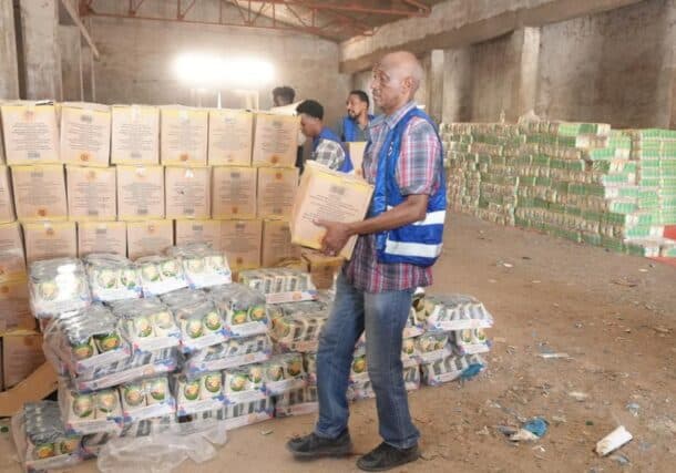 Aid workers distribute food to civiliansn unseen, on April 4, 2026