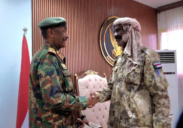 Al-Burhan shakes hands with RSF spinter commander al-Qubba in Dongla, Northern state on April 19, 2026