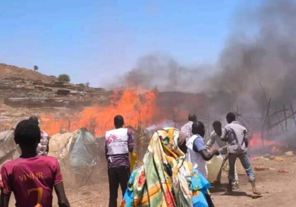 Local residents and aid workers work together to fight a fire at a refugee camp, on April 15, 2026
