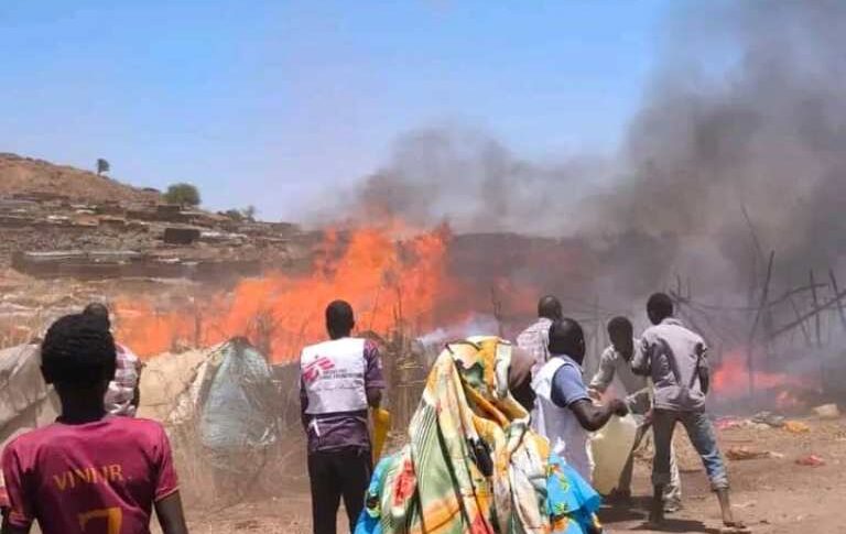Local residents and aid workers work together to fight a fire at a refugee camp, on April 15, 2026