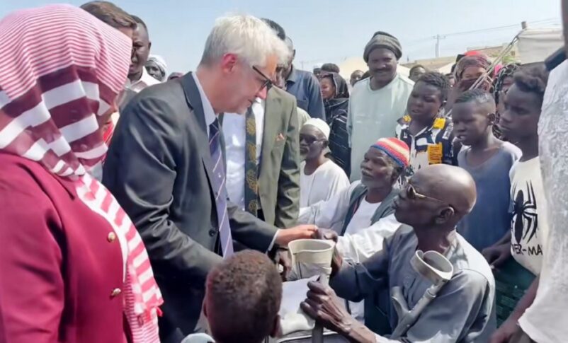French lawmaker Christophe Marion spoeaks with residents of a displacement camp in Port Sudan on May 9, 2026