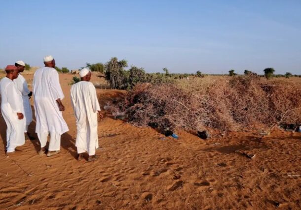 Men from Al-Luwaib village in North Kordofan stand in front of a cemetery where victims of a drone strike were buried, Jan. 14, 2026. Reuters photo