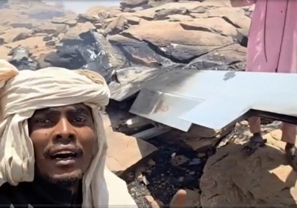 A member of the Rapid Support Forces (RSF) stands near the debris of a drone that the paramilitary group said it shot down in Nyala, May 14, 2026.