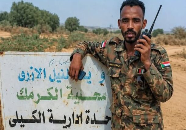 Sudanese military stands at a banner at the entrance of Al Kaily area on May 9, 2026