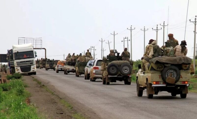Fighters board vehicles of a military convoy in the eastern city of Gedaref, en route to Port Sudan, on August 30, 2023.