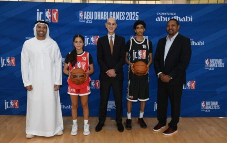 NBA Commissioner Adam Silver (center) poses with officials and young basketball players at an "Abu Dhabi Games 2025" event promoting the league's multi-year partnership with the United Arab Emirates.