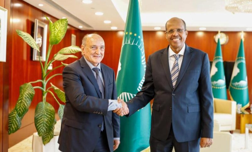 Mahmoud Ali Youssouf, chairperson of the African Union Commission, shakes hands with Mohamed Belaiche, his special representative and head of the AU Liaison Office to Sudan, on June 22, 2026.