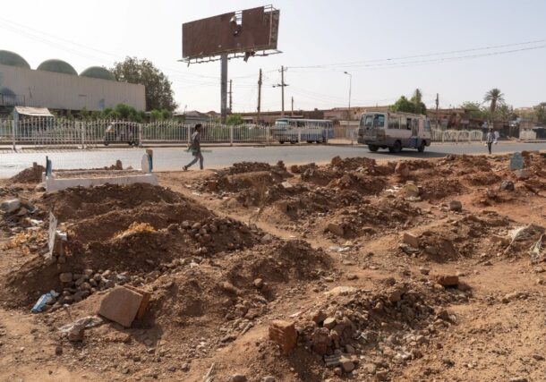 A pedestrian walks past a makeshift roadside graveyard in Omdurman, Sudan, on April 27, 2025, Getty Images