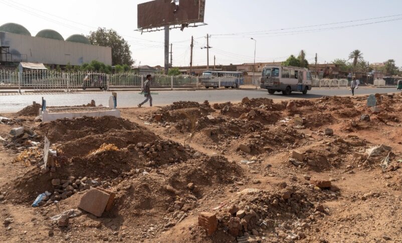 A pedestrian walks past a makeshift roadside graveyard in Omdurman, Sudan, on April 27, 2025, Getty Images