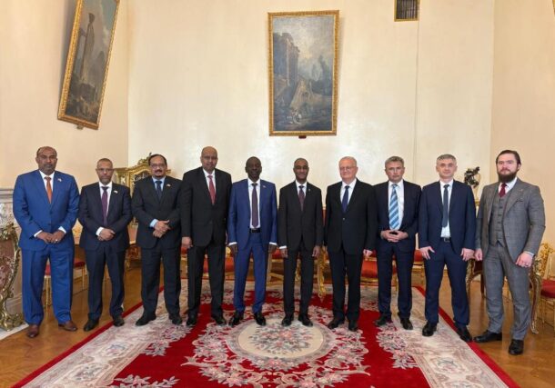 Sudanese and Russian officials pose at the end of a meeting held in Moscow on June 23, 2026