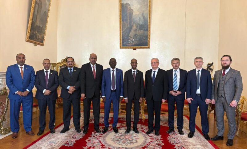 Sudanese and Russian officials pose at the end of a meeting held in Moscow on June 23, 2026