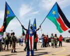 A man carrying South Sudanese flags is seen near the John Garang Mausoleum in Juba, South Sudan, on October 31, 2018. (CNS photo Andreea Campeanu, Reuters)
