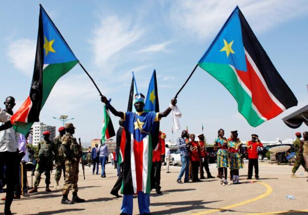 A man carrying South Sudanese flags is seen near the John Garang Mausoleum in Juba, South Sudan, on October 31, 2018. (CNS photo Andreea Campeanu, Reuters)