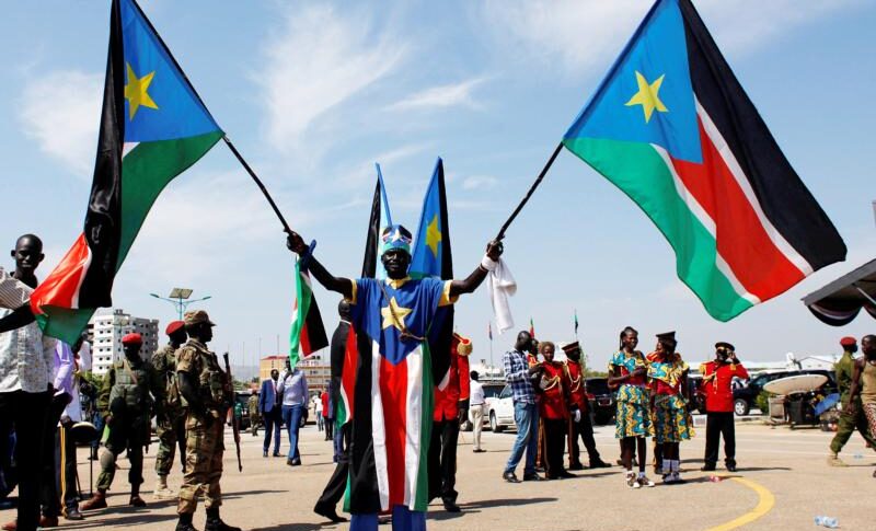 A man carrying South Sudanese flags is seen near the John Garang Mausoleum in Juba, South Sudan, on October 31, 2018. (CNS photo Andreea Campeanu, Reuters)