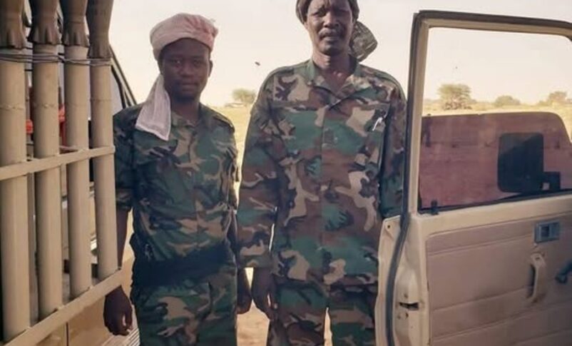 Former Sudanese rebel commander Abdallah Banda, right, poses in military fatigues after rejoining the Justice and Equality Movement (JEM) following the outbreak of conflict between the army and the Rapid Support Forces, in this handout image obtained from social media.