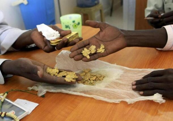 Gold mine workers wait to get their raw gold weighed at a gold shop in Al-Fahir in North Darfur September 24, 2013. Reuters