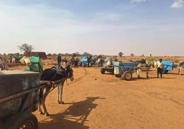 Sudanese child waits to fill plastic jerrycans with water from a mobile distribution truck in El Obeid, North Kordofan State, Sudan.