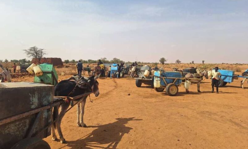 Sudanese child waits to fill plastic jerrycans with water from a mobile distribution truck in El Obeid, North Kordofan State, Sudan.