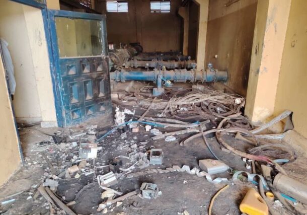 Interior of an abandoned water station with damaged infrastructure and a littered floor in Bara, North Kordofan, Sudan.