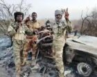 Joint Force members stand next to a destroyed RSF vehicle in Amburu, North Darfur, Aug. 13, 2026.