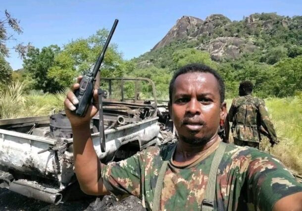 Sudnese army officer stands beside a destroyed Rapid Support Forces (RSF) combat vehicle in Al-Keli, in Sudan's southeastern Blue Nile state, August 27, 2026.