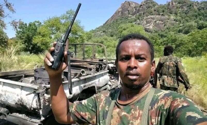 Sudnese army officer stands beside a destroyed Rapid Support Forces (RSF) combat vehicle in Al-Keli, in Sudan's southeastern Blue Nile state, August 27, 2026.