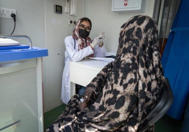 A Sudanese health worker counsels a woman living with HIV after distributing antiretroviral medication, April 2, 2025. UNDP Photo
