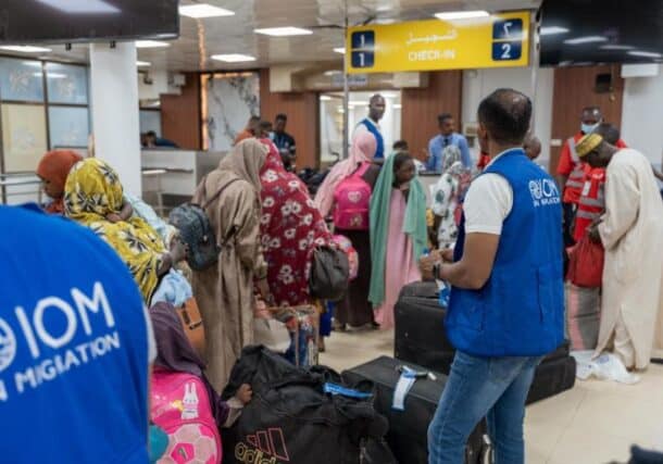 Beneficiaries of the IOM's Assisted Voluntary Return Programme wait to check in for the first voluntary return flight at Khartoum Airport, on September 3, 2026. IOM photo