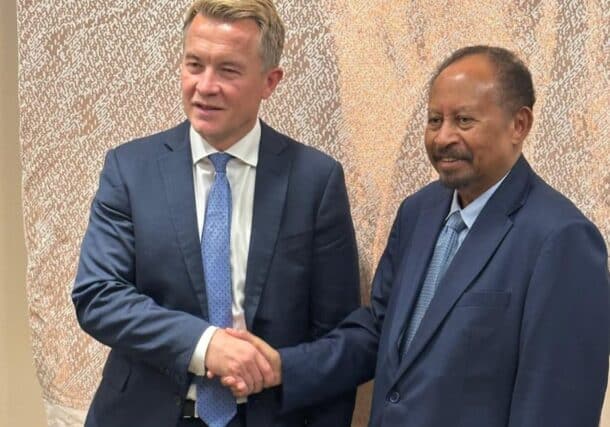 Former prime minister Abdalla Hamdok, shakes hands with Norwegian State Secretary Andreas Kravik in New York on Sept 22, 2026