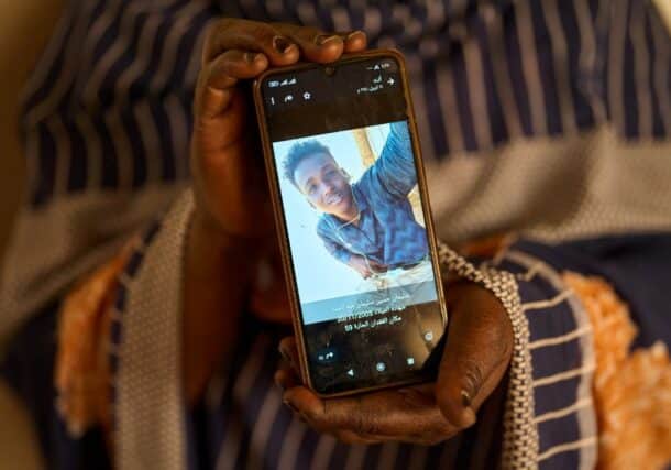 Sulafa Mustafa shows a photograph of her missing son, Suleiman Abdelsaid, in Omdurman, Sudan, on April 21, 2026. AP Photo