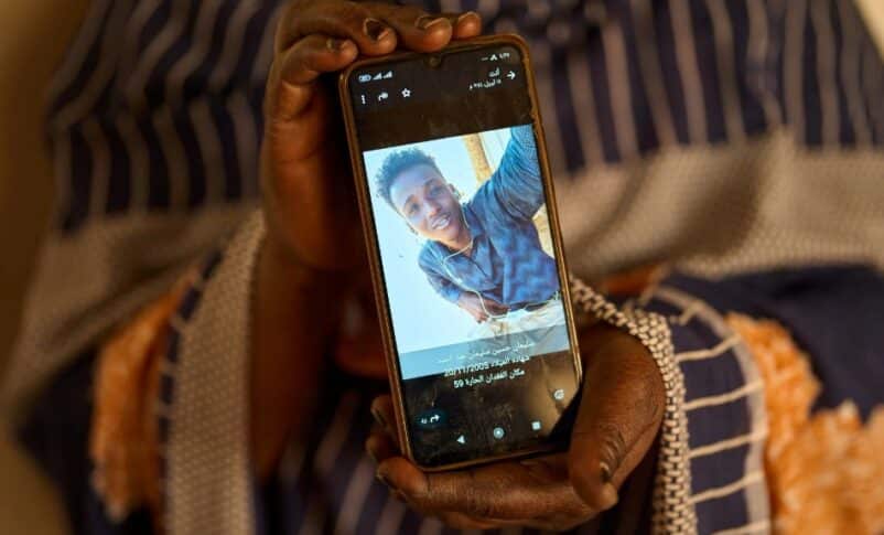 Sulafa Mustafa shows a photograph of her missing son, Suleiman Abdelsaid, in Omdurman, Sudan, on April 21, 2026. AP Photo