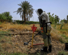 A deminer uses a metal probe as he searches for land mines in Al-Mugran Park in Khartoum on April 19, 2026. AFP
