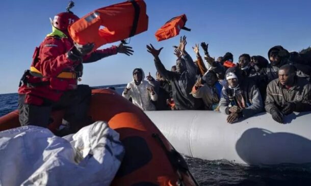 African migrants on a makeshift rubber boat receive life jackets from a Spanish NGO off the Libyan coast, Jan. 28, 2022.AP photo