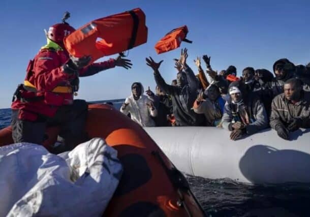 African migrants on a makeshift rubber boat receive life jackets from a Spanish NGO off the Libyan coast, Jan. 28, 2022.AP photo