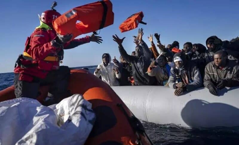 African migrants on a makeshift rubber boat receive life jackets from a Spanish NGO off the Libyan coast, Jan. 28, 2022.AP photo