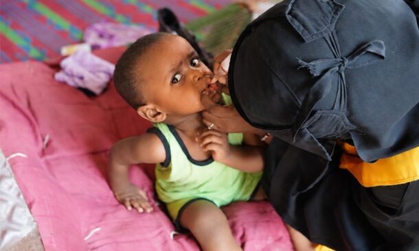 An infant boy receives the nOPV polio vaccine at home in Port Sudan, Red Sea State, on the first day of a campaign aiming to protect 11 million children from polio, October 26, 2026. WHO/Handout