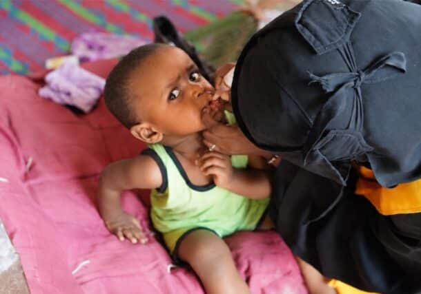 An infant boy receives the nOPV polio vaccine at home in Port Sudan, Red Sea State, on the first day of a campaign aiming to protect 11 million children from polio, October 26, 2026. WHO/Handout